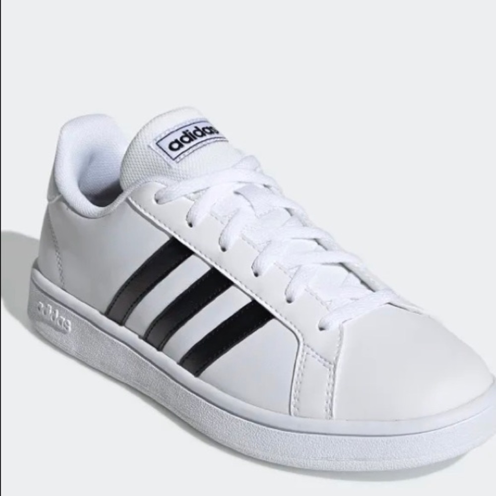 White Adidas Sneakers with the black stripes.